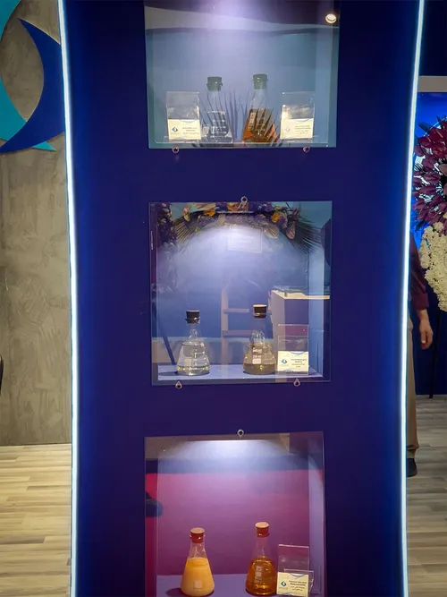 Blue display columns holding labelled flasks of liquid chemical samples