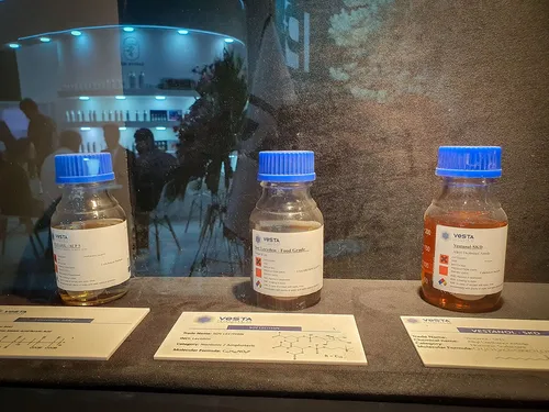 Three Vesta chemical sample bottles with descriptive cards in a case