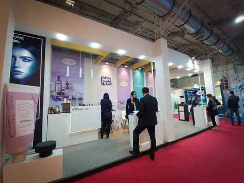 Skincare booth with product banners, welcome desk, and visitors