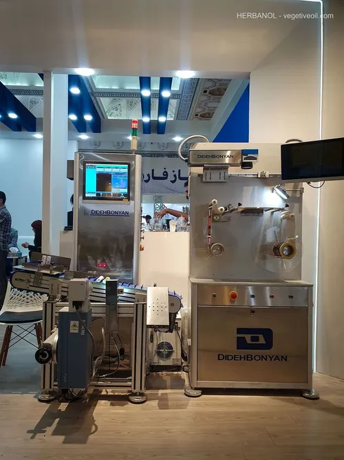 DidehBonyan inspection machine with conveyor and control screens at booth