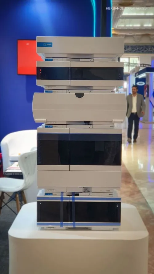 Stacked white Agilent laboratory chromatography instruments on display pedestal