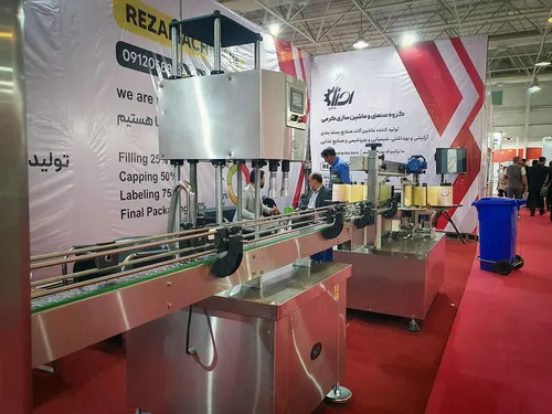 Filling and capping packaging line with conveyor at an exhibition stand