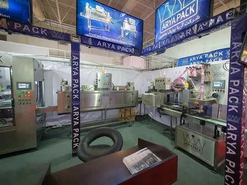 Arya Pack booth with shrink sleeve labelling machinery and overhead screens