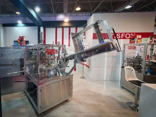 Tisfon tube filling machine and equipment at a red-accented booth