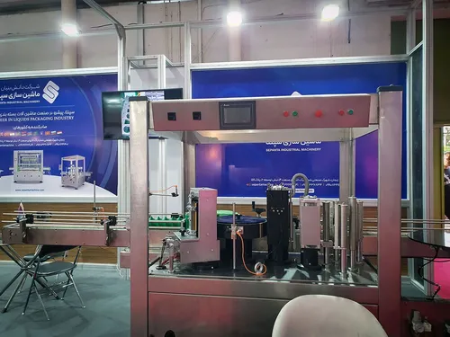Sepanta Industrial Machinery rotary labelling machine on a conveyor line