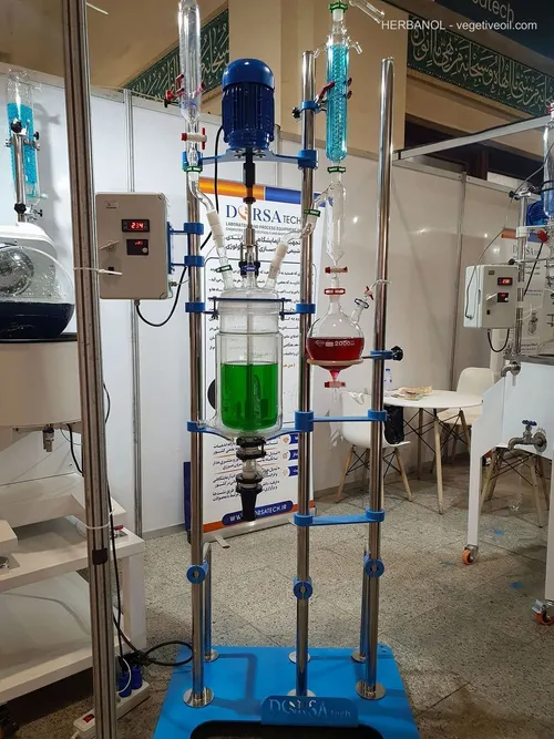DorsaTech jacketed glass reactor with green liquid and condensers